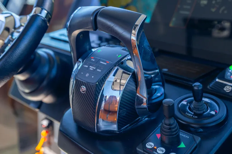 Slide: The Image of Control panel of a 2021 Saxdor 320 GTO boat, featuring modern throttle and joystick. - 30