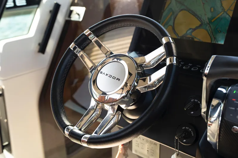 Slide: The Image of Steering wheel of 2021 Saxdor 320 GTO boat with navigation display. - 31