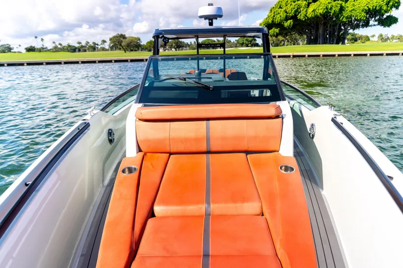 Slide: The Image of 2021 Saxdor 320 GTO boat with orange seating, docked on a sunny day. - 35