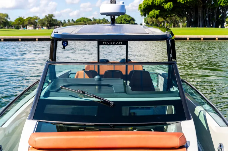 Slide: The Image of 2021 Saxdor 320 GTO boat on water, featuring sleek design and modern windshield. - 36