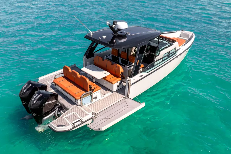Slide: The Image of 2021 Saxdor 320 GTO boat with orange seating on turquoise water. - 4