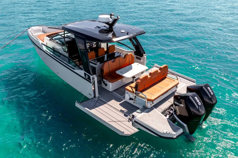 Slide: The Image of 2021 Saxdor 320 GTO boat on clear turquoise water, featuring sleek design and powerful engines. - 6
