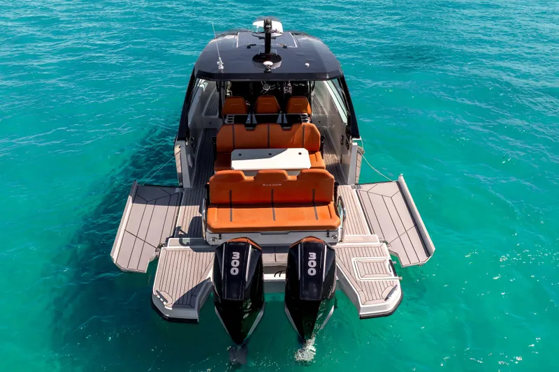Slide: The Image of 2021 Saxdor 320 GTO boat with twin engines on turquoise water. - 9