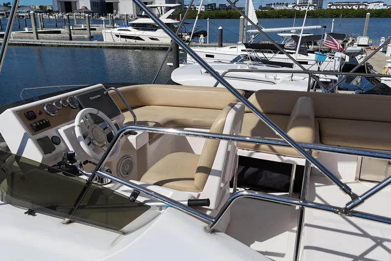 Slide: The Image of Flybridge of 2012 Azimut 40 FLY yacht with beige seating and steering wheel. - 10