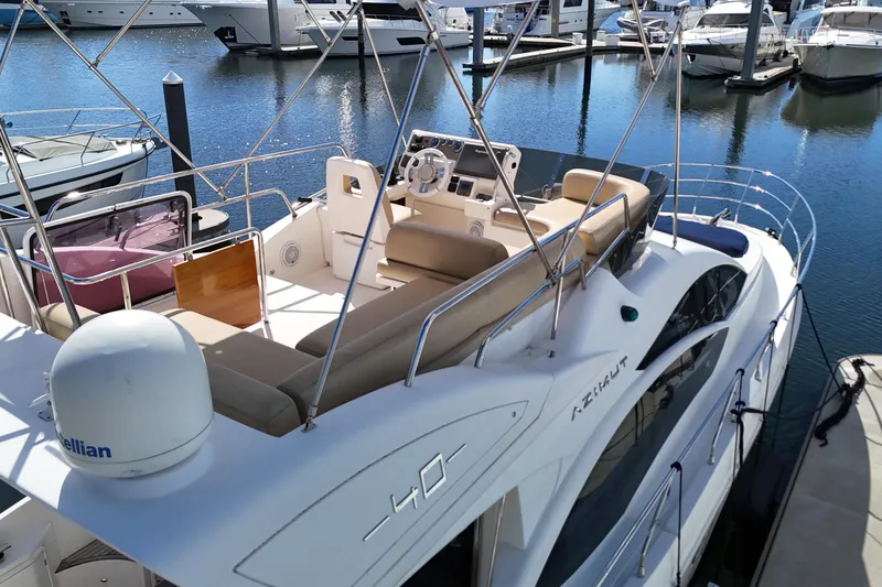 Slide: The Image of 2012 Azimut 40 FLY yacht docked at marina, featuring spacious flybridge and elegant design. - 13