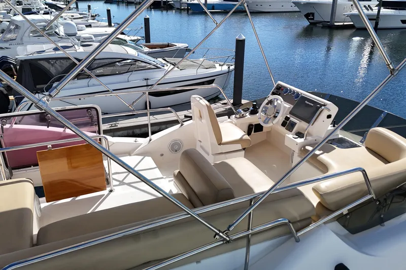 Slide: The Image of Flybridge of 2012 Azimut 40 FLY yacht docked at marina, featuring helm and seating area. - 14