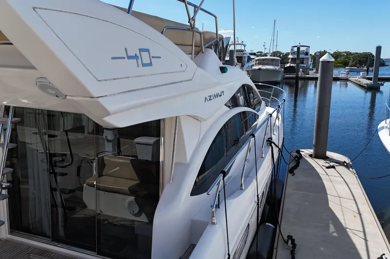 Slide: The Image of Azimut 40 FLY 2012 yacht docked at marina, showcasing sleek design and luxury features. - 15