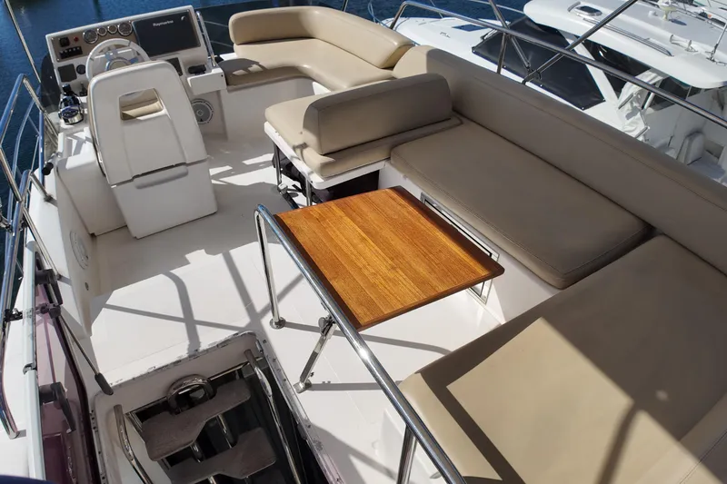 Slide: The Image of Flybridge of 2012 Azimut 40 FLY yacht with seating and wooden table. - 16