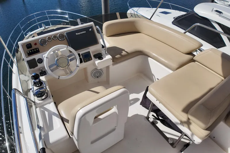 Slide: The Image of Flybridge of 2012 Azimut 40 FLY yacht with beige seating and modern controls. - 17