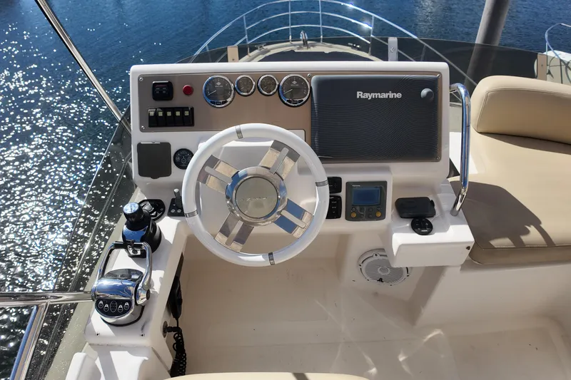 Slide: The Image of Helm of 2012 Azimut 40 FLY yacht with Raymarine navigation system and luxurious seating. - 18