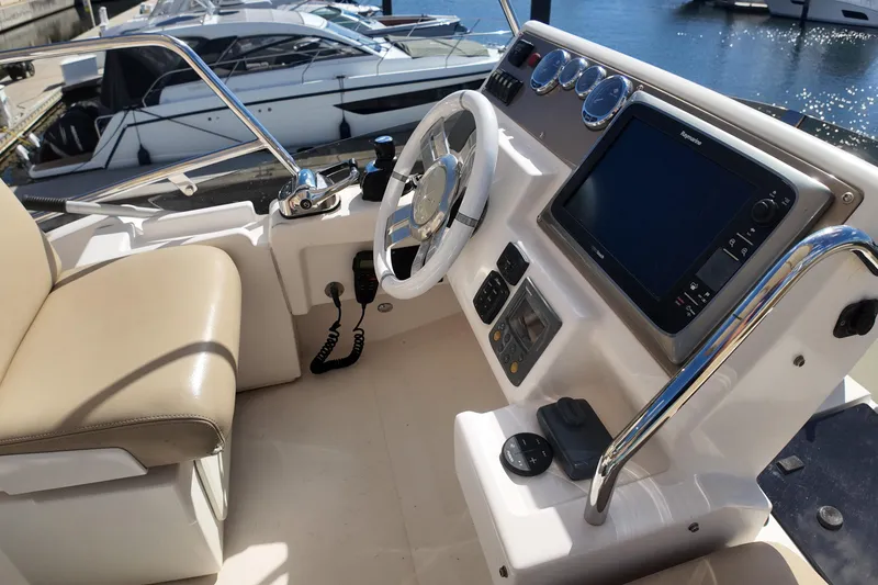Slide: The Image of Cockpit of 2012 Azimut 40 FLY yacht with steering wheel and navigation controls. - 19