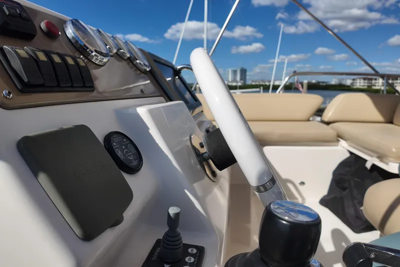 Slide: The Image of Helm of 2012 Azimut 40 FLY yacht with steering wheel and controls, under clear blue sky. - 21
