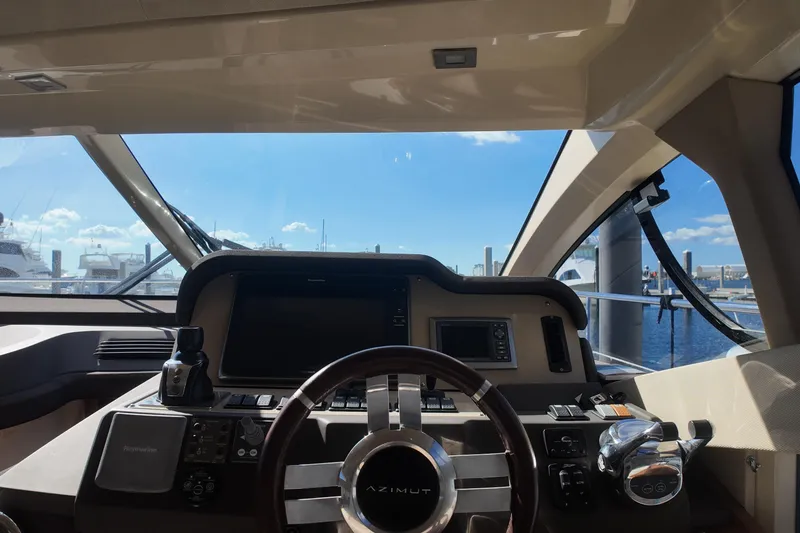 Slide: The Image of Cockpit view of 2012 Azimut 40 FLY yacht with steering wheel and navigation controls. - 22