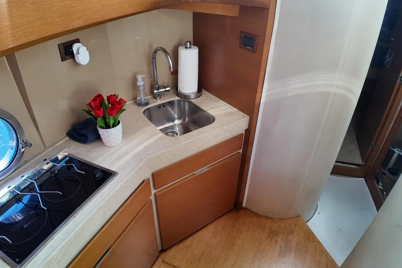 Slide: The Image of Compact kitchen area in 2012 Azimut 40 FLY yacht with sink and stove. - 31