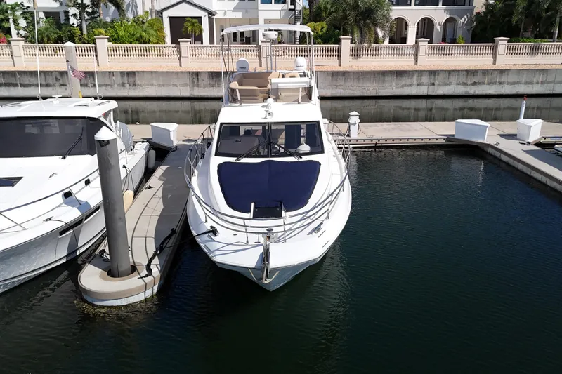 Slide: The Image of 2012 Azimut 40 FLY yacht docked at marina, surrounded by calm water. - 4