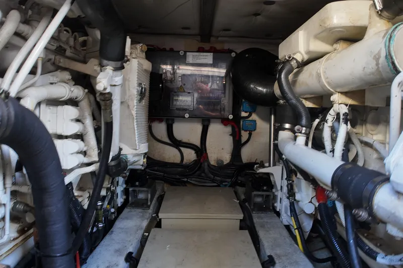 Slide: The Image of Engine room of a 2012 Azimut 40 FLY yacht, showcasing mechanical components and wiring. - 44