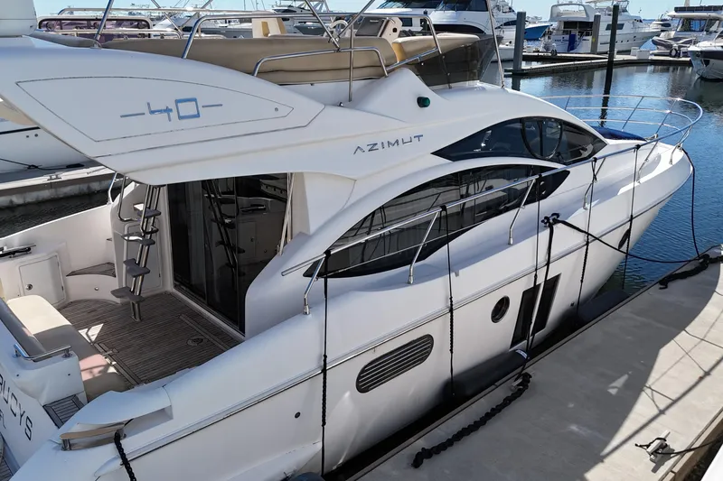 Slide: The Image of Azimut 40 FLY 2012 yacht docked at marina, showcasing sleek design and luxury features. - 6