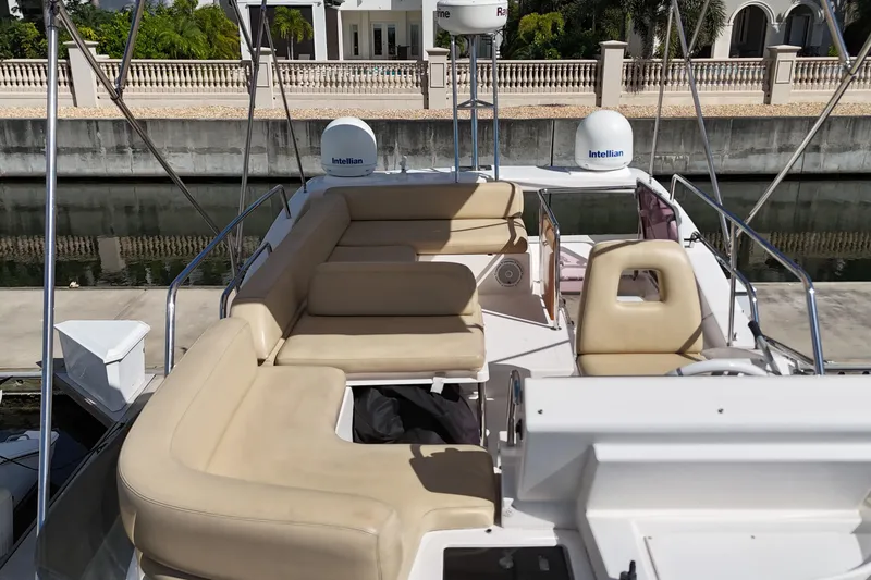 Slide: The Image of Flybridge seating area on a 2012 Azimut 40 FLY yacht, docked by a canal. - 8