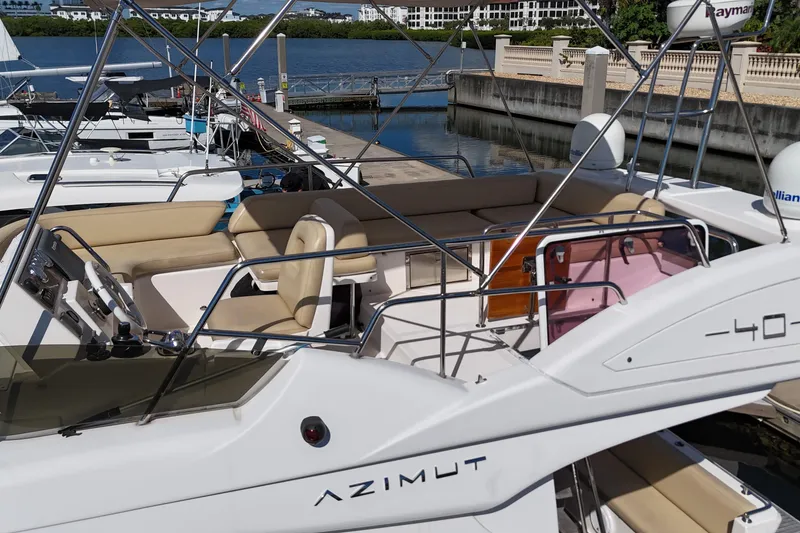 Slide: The Image of 2012 Azimut 40 FLY yacht docked, featuring spacious seating and sleek design. - 9