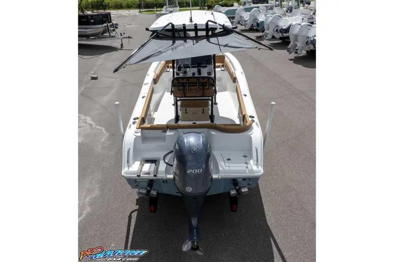 Slide: The Image of 2022 Sea Hunt Ultra 229 boat with Yamaha 200 engine, parked outdoors. - 12