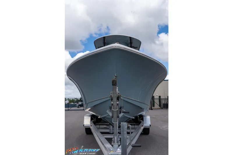 Slide: The Image of 2022 Sea Hunt Ultra 229 boat on trailer, viewed from front under cloudy sky. - 19