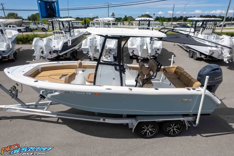 Slide: The Image of 2022 Sea Hunt Ultra 229 boat on trailer, surrounded by other boats in a dealership lot. - 20