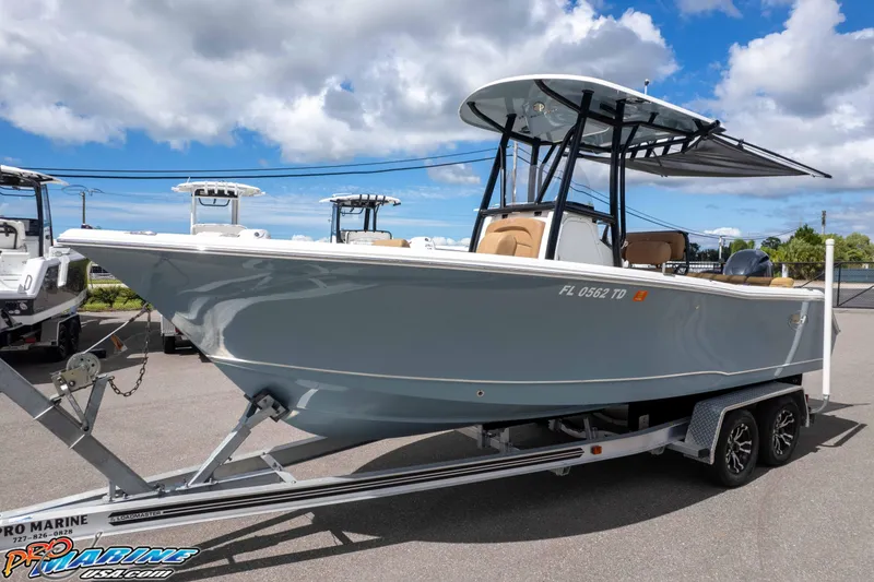 Slide: The Image of 2022 Sea Hunt Ultra 229 boat on trailer under blue sky. - 22