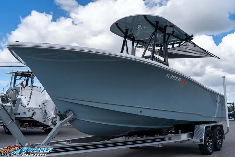 Slide: The Image of 2022 Sea Hunt Ultra 229 boat on trailer under cloudy sky. - 23