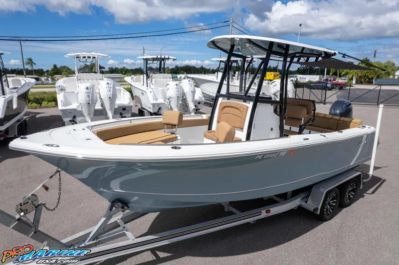 Slide: The Image of 2022 Sea Hunt Ultra 229 boat on trailer, displayed outdoors under blue sky. - 24