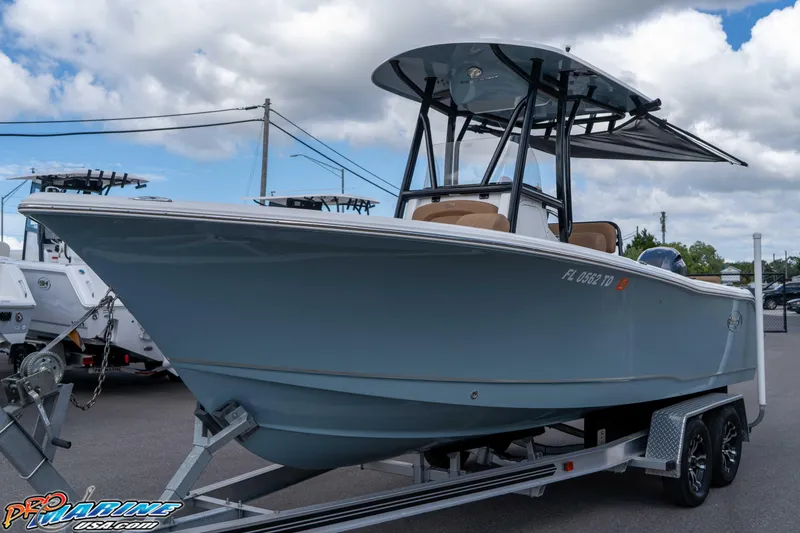 Slide: The Image of 2022 Sea Hunt Ultra 229 boat on trailer under cloudy sky. - 25