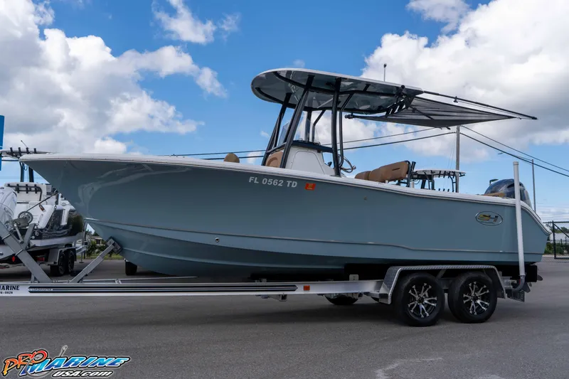 Slide: The Image of 2022 Sea Hunt Ultra 229 boat on trailer under blue sky. - 27