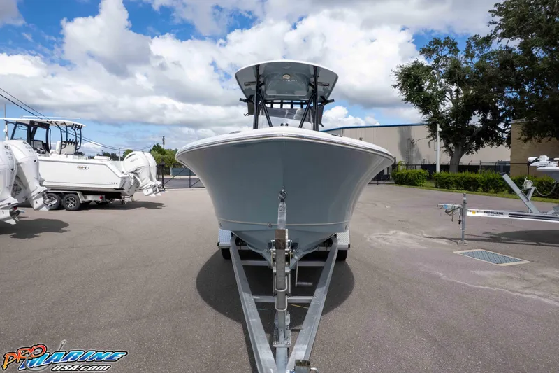 Slide: The Image of 2022 Sea Hunt Ultra 229 boat on trailer in outdoor lot, under blue sky. - 28