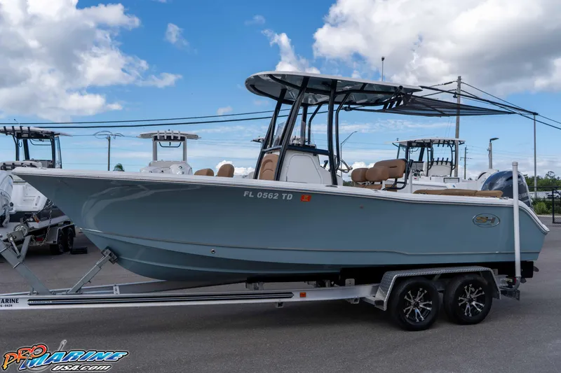 Slide: The Image of 2022 Sea Hunt Ultra 229 boat on trailer under blue sky. - 29