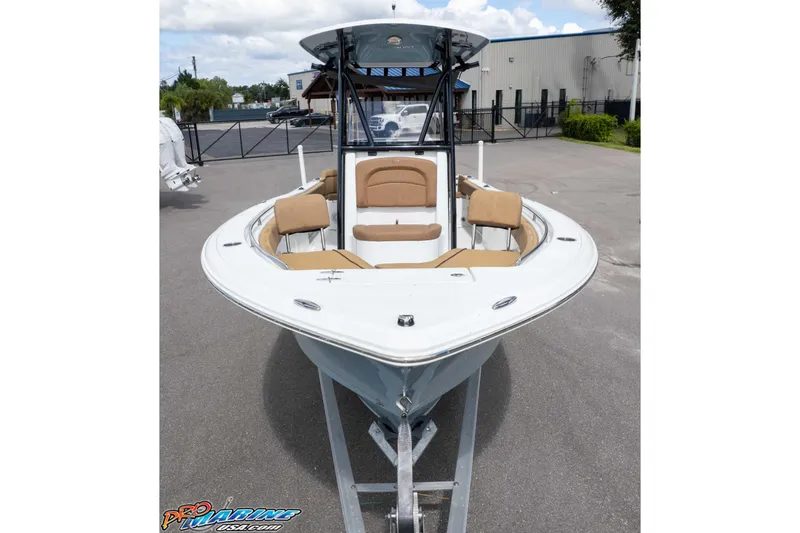 Slide: The Image of 2022 Sea Hunt Ultra 229 boat with tan seating, displayed outdoors on a trailer. - 30