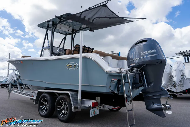 Slide: The Image of 2022 Sea Hunt Ultra 229 boat with Yamaha engine on trailer, under cloudy sky. - 31
