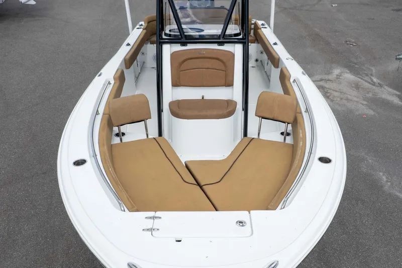 Slide: The Image of 2022 Sea Hunt Ultra 229 boat interior with tan seating and sleek design. - 32