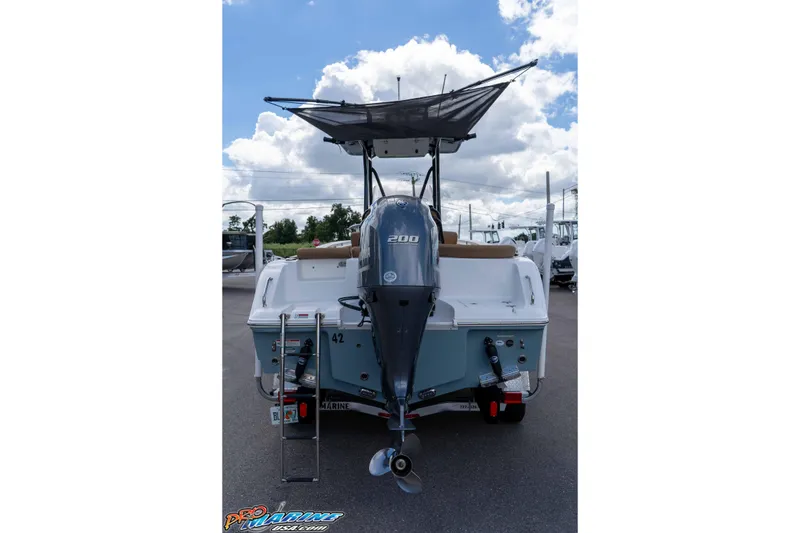 Slide: The Image of 2022 Sea Hunt Ultra 229 boat with outboard motor, rear view under cloudy sky. - 37