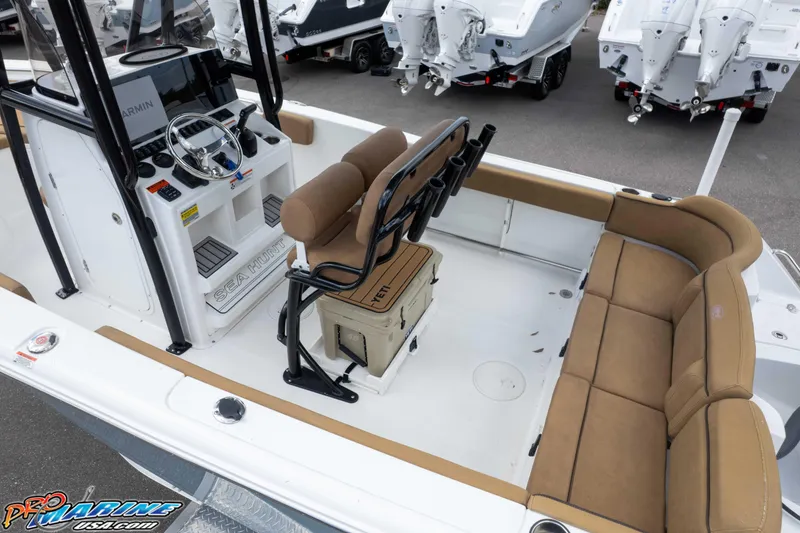 Slide: The Image of 2022 Sea Hunt Ultra 229 boat interior with tan seating and modern console. - 38