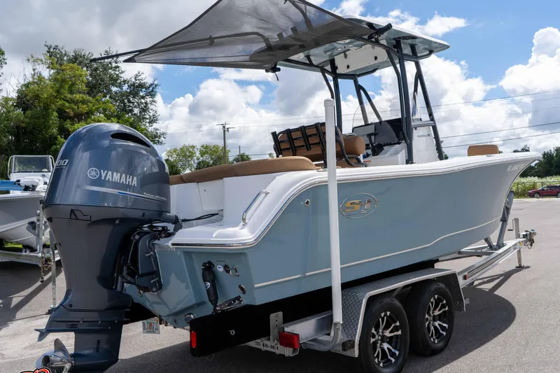 Slide: The Image of 2022 Sea Hunt Ultra 229 boat with Yamaha engine on trailer, under clear sky. - 39