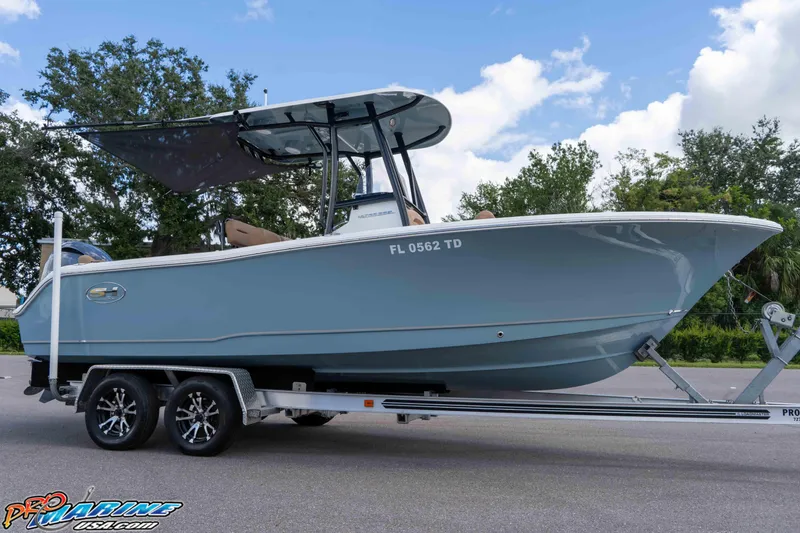 Slide: The Image of 2022 Sea Hunt Ultra 229 boat on trailer, parked outdoors under blue sky. - 40
