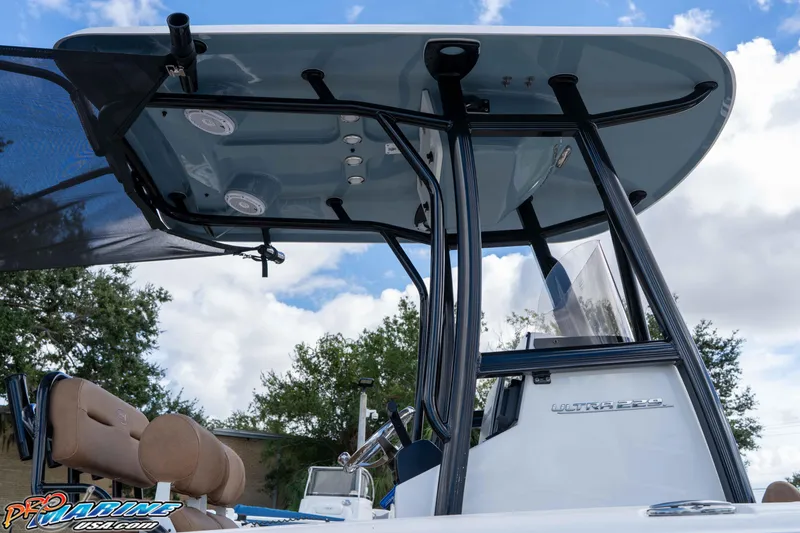 Slide: The Image of 2022 Sea Hunt Ultra 229 boat with T-top and seating, under a partly cloudy sky. - 41