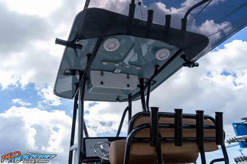 Slide: The Image of 2022 Sea Hunt Ultra 229 boat with T-top and rod holders against cloudy sky. - 43