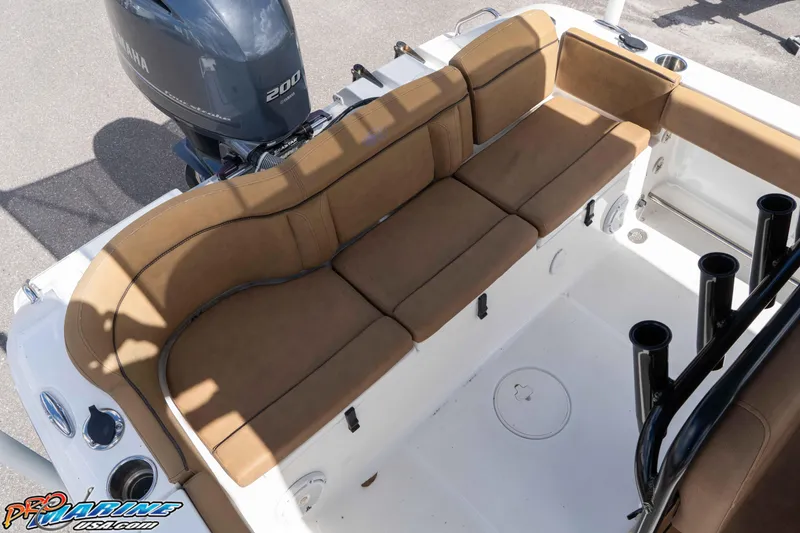 Slide: The Image of 2022 Sea Hunt Ultra 229 boat interior with tan seating and Yamaha 200 engine. - 45
