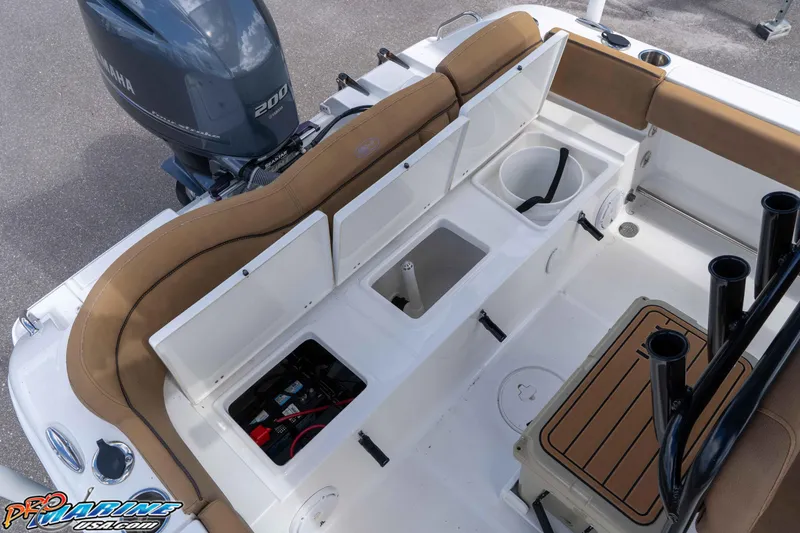 Slide: The Image of 2022 Sea Hunt Ultra 229 boat interior with Yamaha 200 engine, featuring storage compartments and seating. - 46