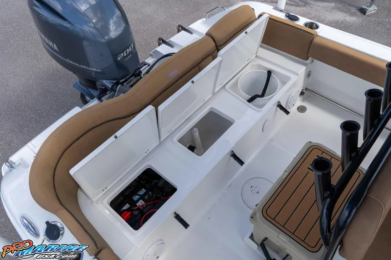 Slide: The Image of 2022 Sea Hunt Ultra 229 boat interior with Yamaha 200 engine, storage compartments, and seating. - 47