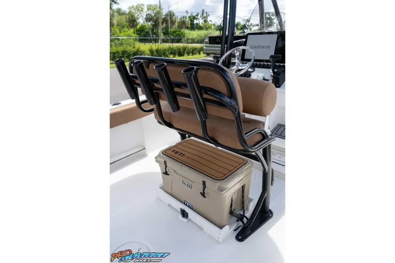 Slide: The Image of 2022 Sea Hunt Ultra 229 boat interior with rod holders and Yeti cooler. - 48