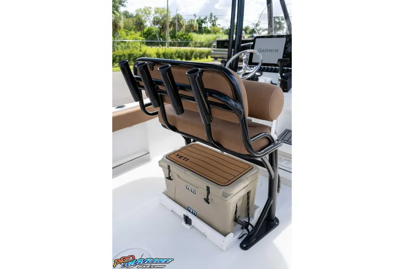 Slide: The Image of 2022 Sea Hunt Ultra 229 boat interior with rod holders and Yeti cooler. - 49