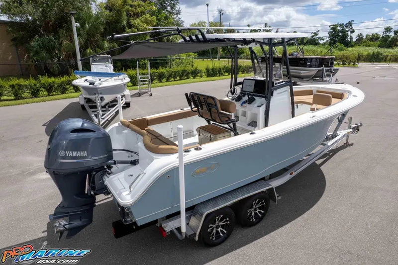 Slide: The Image of 2022 Sea Hunt Ultra 229 boat with Yamaha engine on trailer, parked outdoors. - 8