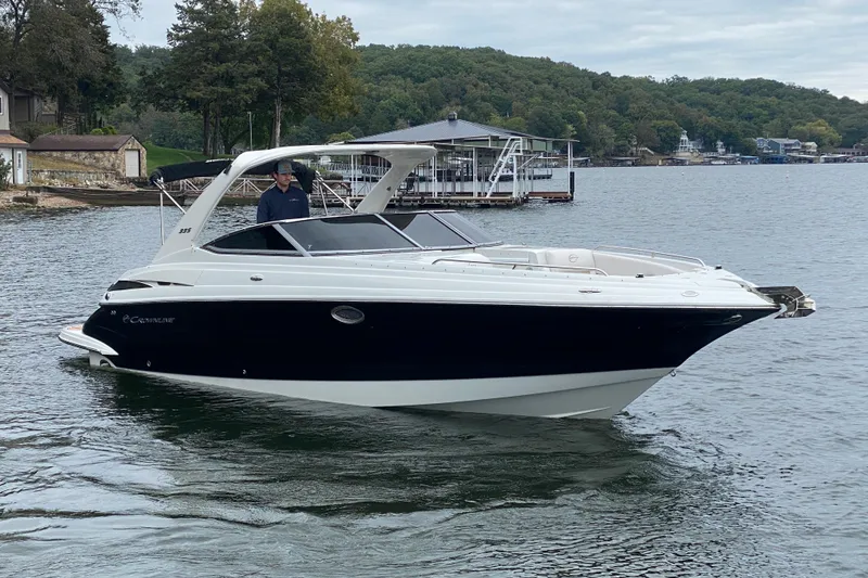 Slide: The Image of 2015 Crownline 335 SS boat on a lake with scenic background. - 1