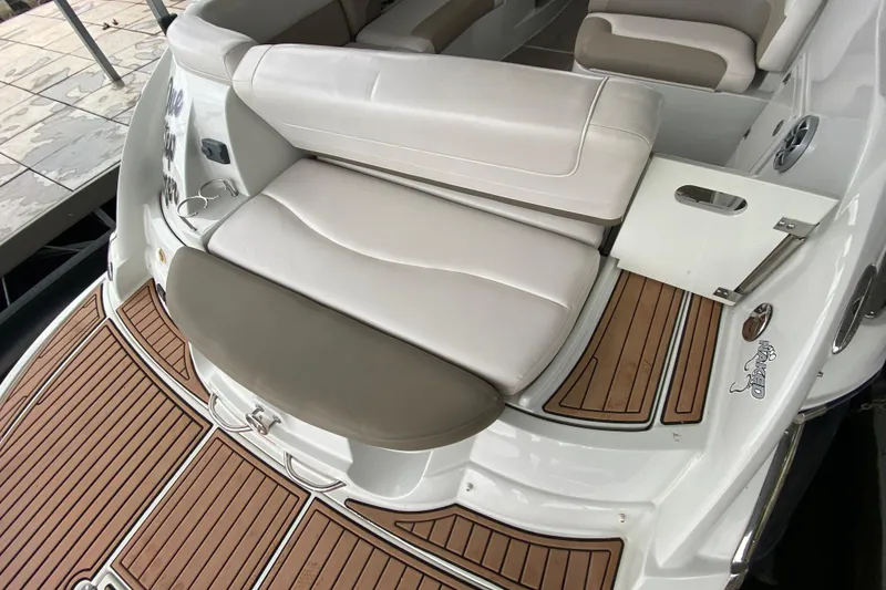 Slide: The Image of 2015 Crownline 335 SS boat with cushioned seating and teak flooring. - 12